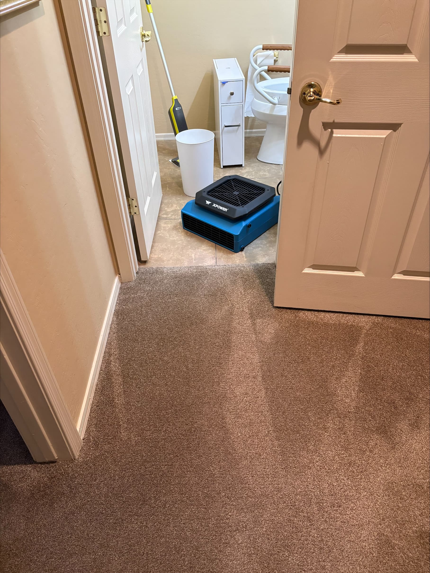 Professional drying equipment restoring a bathroom after water damage