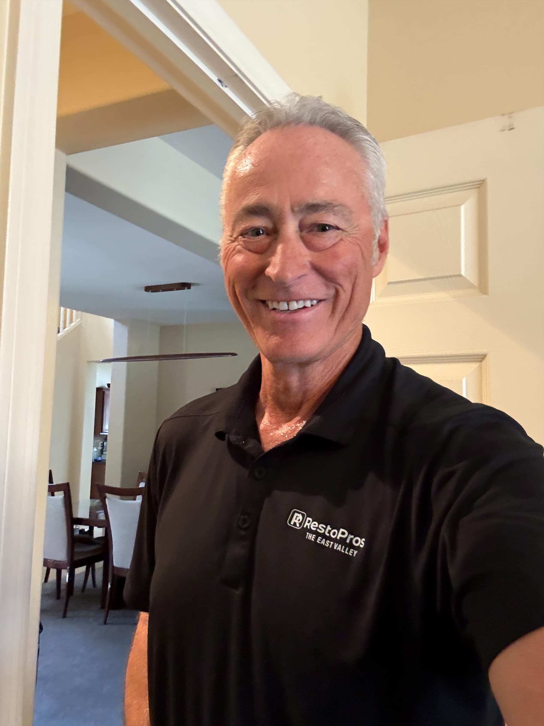 Owner of RestoPros of the East Valley in a branded company polo shirt